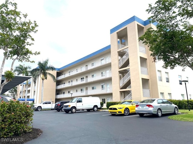 14801 Park Lake Dr Unit 203, Fort Myers, FL 33919 - view of building exterior with uncovered parking