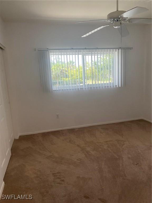 14801 Park Lake Dr Unit 203, Fort Myers, FL 33919 - empty room featuring plenty of natural light, ceiling fan, and carpet