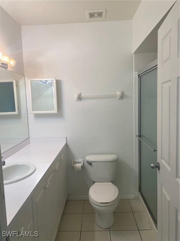 14801 Park Lake Dr Unit 203, Fort Myers, FL 33919 - full bathroom with toilet, visible vents, tile patterned flooring, and vanity