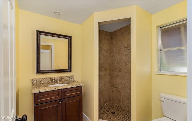 full bathroom with toilet, a shower stall, and vanity