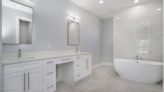 bathroom with recessed lighting, a sink, marble finish floor, a soaking tub, and double vanity