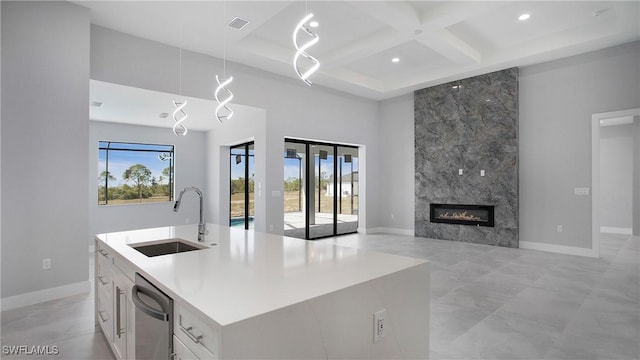 kitchen featuring visible vents, a towering ceiling, a sink, coffered ceiling, and dishwasher