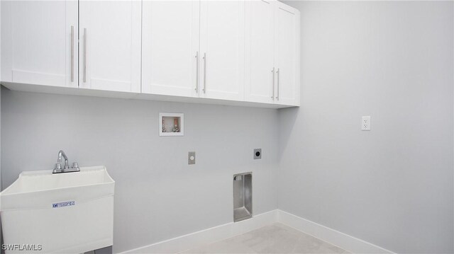 laundry room featuring hookup for a washing machine, hookup for an electric dryer, a sink, baseboards, and cabinet space