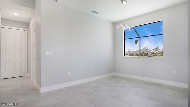 unfurnished room featuring visible vents and baseboards