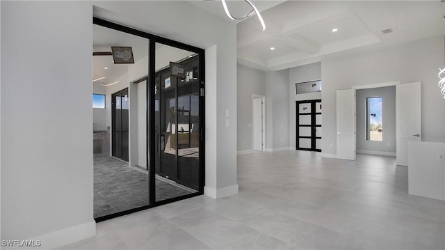 entrance foyer with recessed lighting, coffered ceiling, a towering ceiling, baseboards, and beamed ceiling