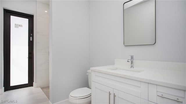 bathroom featuring toilet and vanity