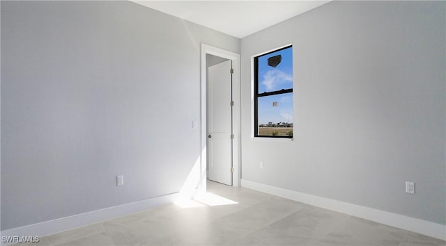 spare room featuring baseboards