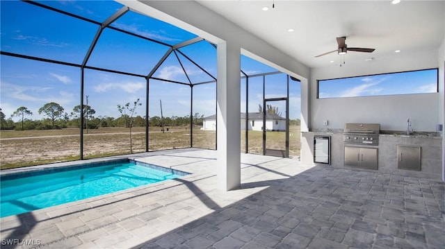 view of swimming pool with a patio, area for grilling, a grill, and a lanai