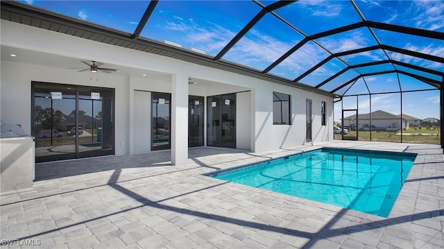 pool with a lanai, a patio area, and ceiling fan