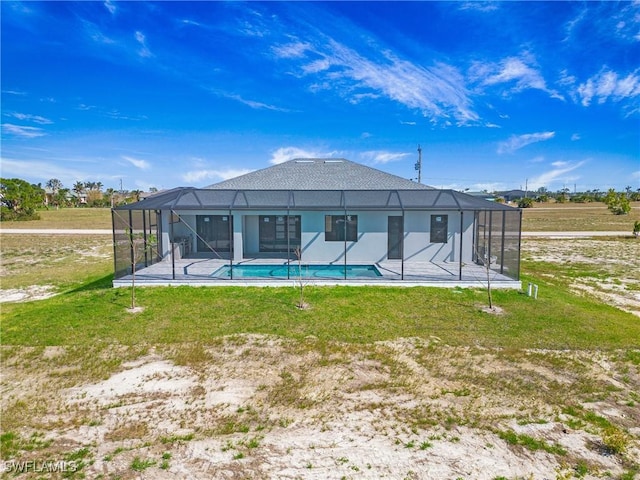 back of property with stucco siding, a lawn, a patio area, a lanai, and an outdoor pool