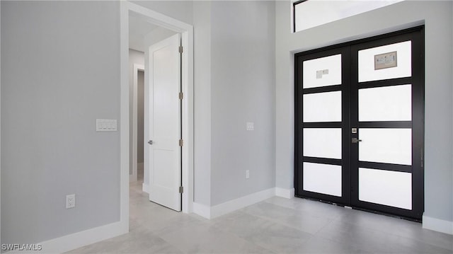 foyer featuring french doors and baseboards