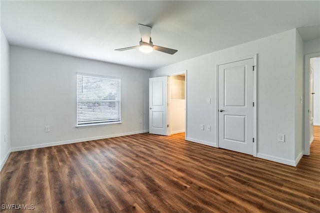 unfurnished bedroom featuring a ceiling fan, dark wood-style flooring, and baseboards