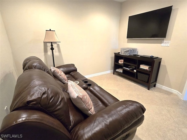 living area featuring light tile patterned floors and baseboards