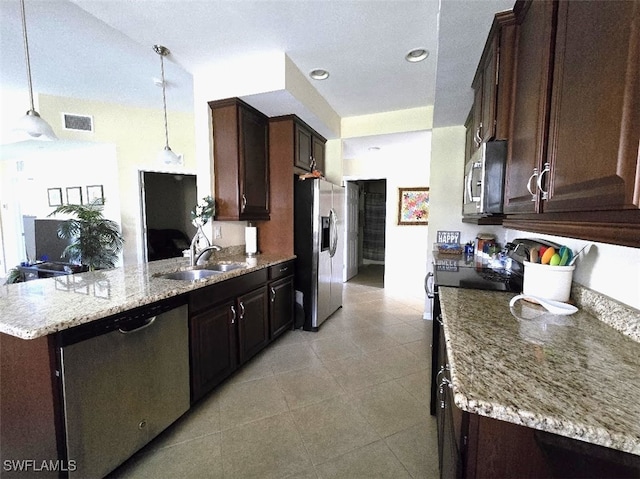 kitchen with dark brown cabinetry, visible vents, appliances with stainless steel finishes, and decorative light fixtures