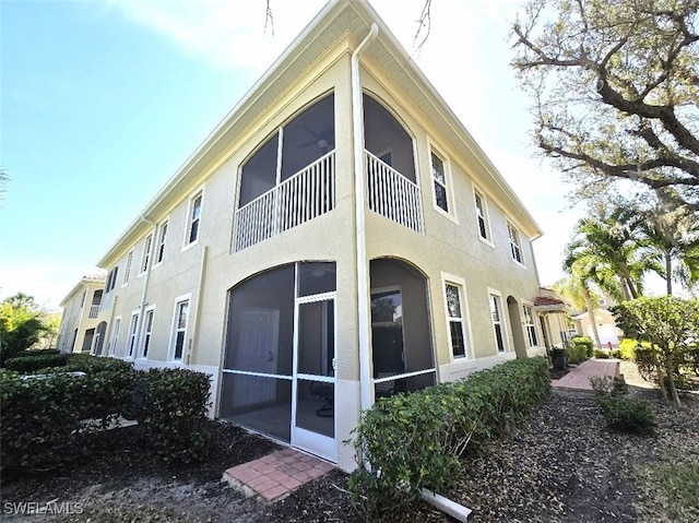 view of side of home with stucco siding