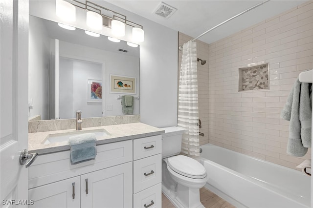 full bathroom with toilet, vanity, visible vents, and shower / bathtub combination with curtain