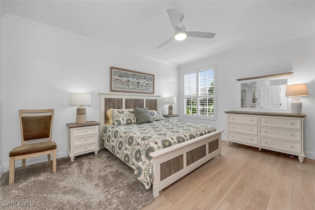 bedroom with baseboards, ceiling fan, wood finished floors, and crown molding