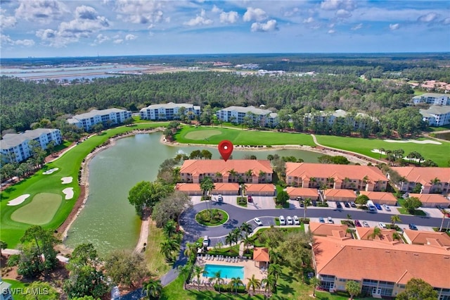 drone / aerial view with a water view, view of golf course, and a residential view