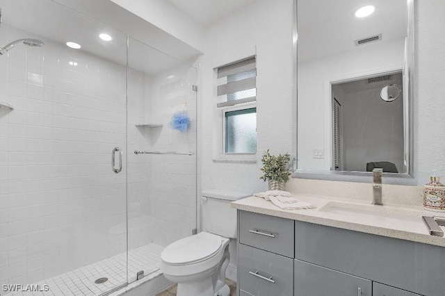 full bath with recessed lighting, visible vents, toilet, vanity, and a shower stall