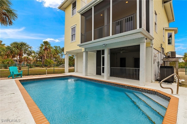 rear view of property with a patio, fence, a fenced in pool, and central air condition unit