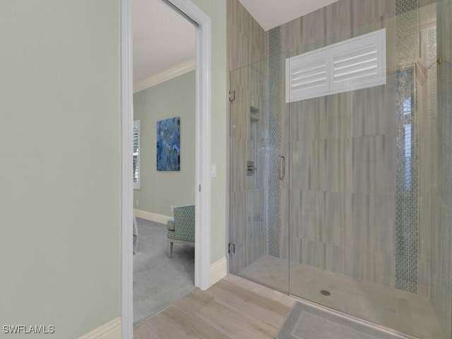 7627 Palmer Ct, Naples, FL 34113 - bathroom with ornamental molding, baseboards, a shower stall, and wood finished floors