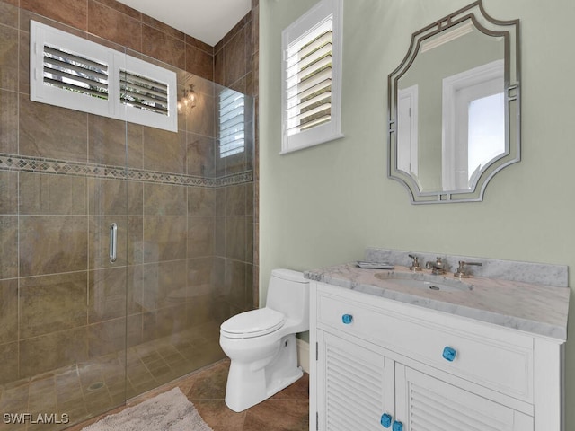 7627 Palmer Ct, Naples, FL 34113 - bathroom featuring tile patterned flooring, toilet, a shower stall, and vanity