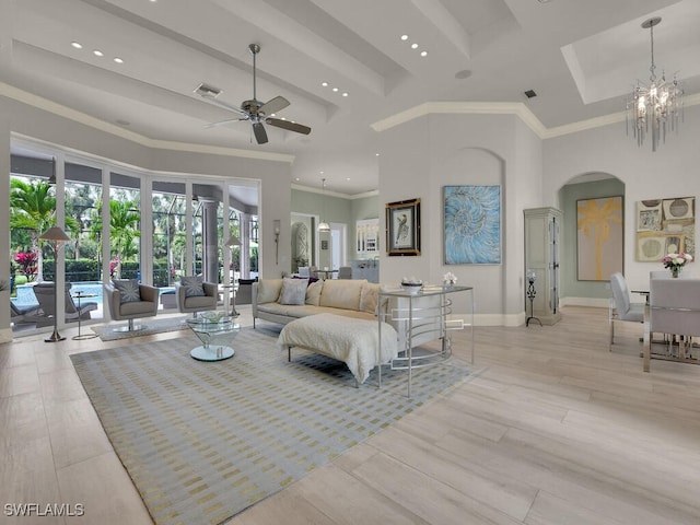 7627 Palmer Ct, Naples, FL 34113 - living area with visible vents, baseboards, arched walkways, a high ceiling, and ceiling fan with notable chandelier