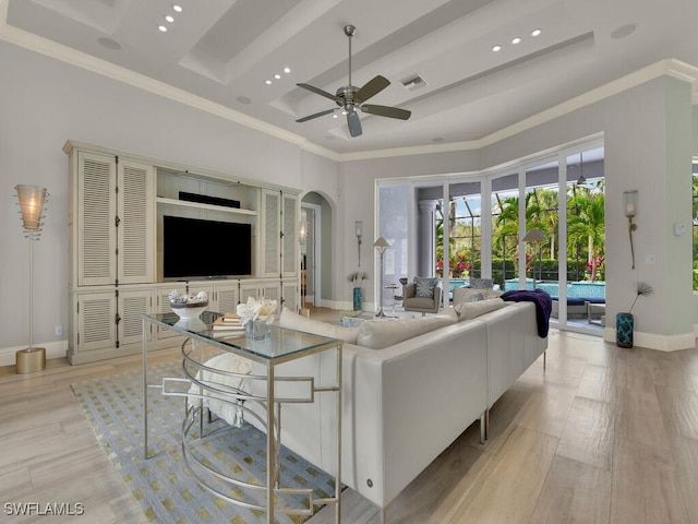 7627 Palmer Ct, Naples, FL 34113 - living room with arched walkways, light wood finished floors, and ornamental molding