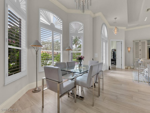 7627 Palmer Ct, Naples, FL 34113 - dining area featuring crown molding, baseboards, an inviting chandelier, and light wood-style floors
