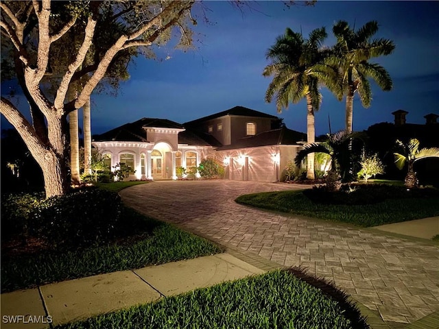 7627 Palmer Ct, Naples, FL 34113 - mediterranean / spanish-style house featuring an attached garage and decorative driveway