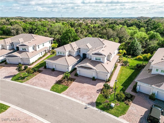 bird's eye view with a wooded view