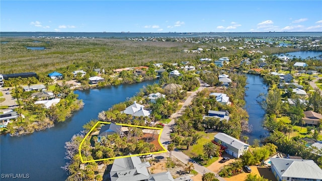 drone / aerial view with a residential view and a water view