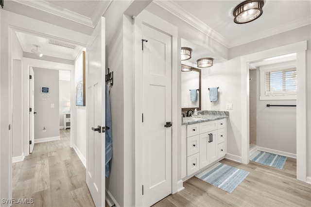 full bathroom with visible vents, crown molding, baseboards, wood finished floors, and vanity