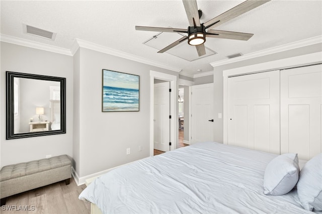 bedroom featuring visible vents, crown molding, and light wood-type flooring