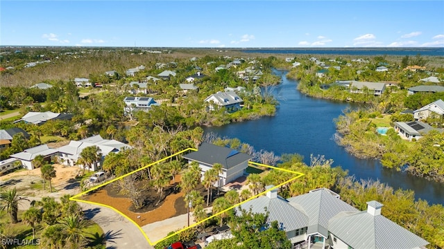 drone / aerial view with a water view and a residential view