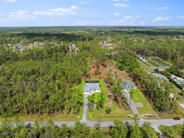 drone / aerial view with a wooded view