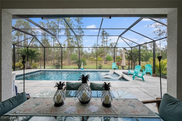 pool with glass enclosure and a patio