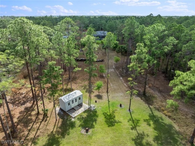 birds eye view of property with a view of trees