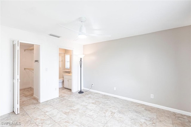 unfurnished bedroom with baseboards, a spacious closet, visible vents, and a closet