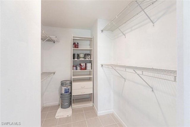 spacious closet featuring light tile patterned floors