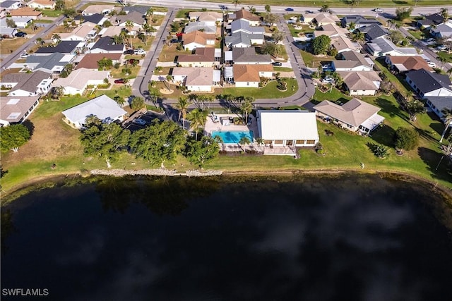 drone / aerial view featuring a water view and a residential view