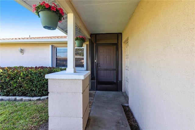 doorway to property with stucco siding