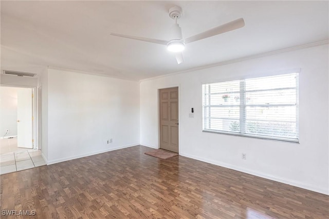 unfurnished room featuring ceiling fan, wood finished floors, visible vents, and baseboards