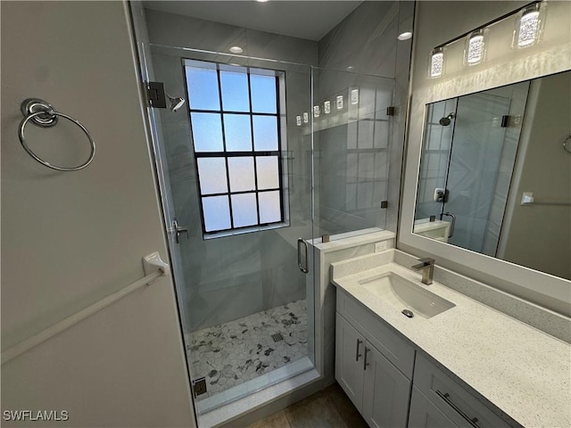 full bath with a stall shower and vanity