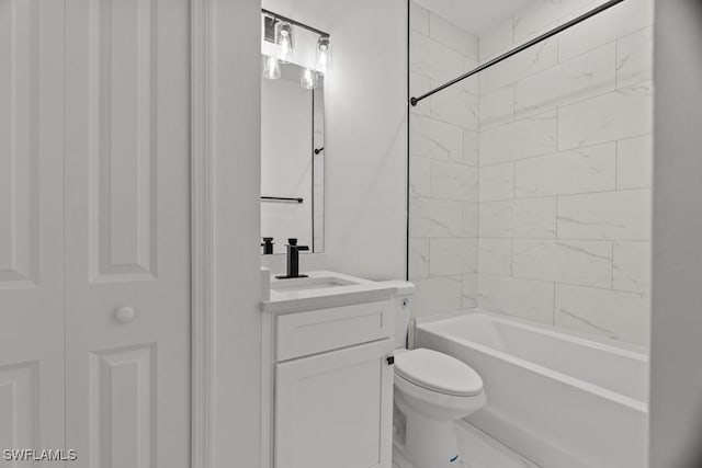 bathroom featuring washtub / shower combination, vanity, and toilet