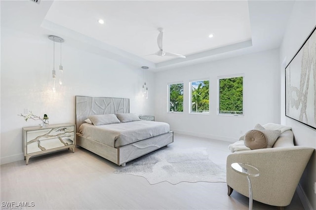 bedroom with recessed lighting, a raised ceiling, and baseboards