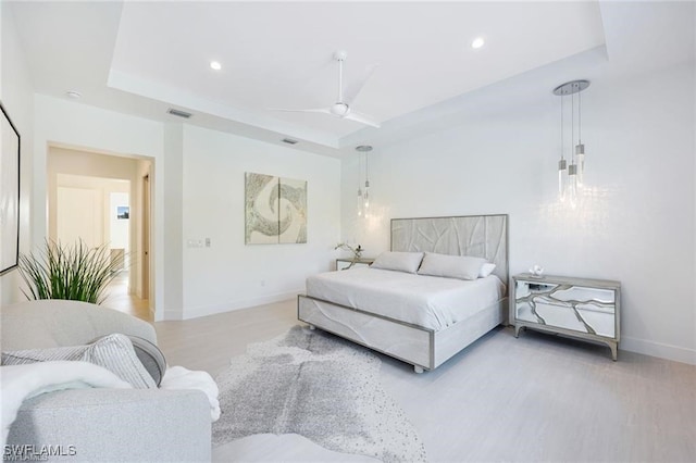 bedroom featuring recessed lighting, a raised ceiling, visible vents, and baseboards