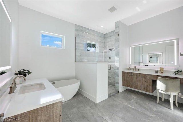 full bathroom with a stall shower, visible vents, a freestanding tub, and vanity