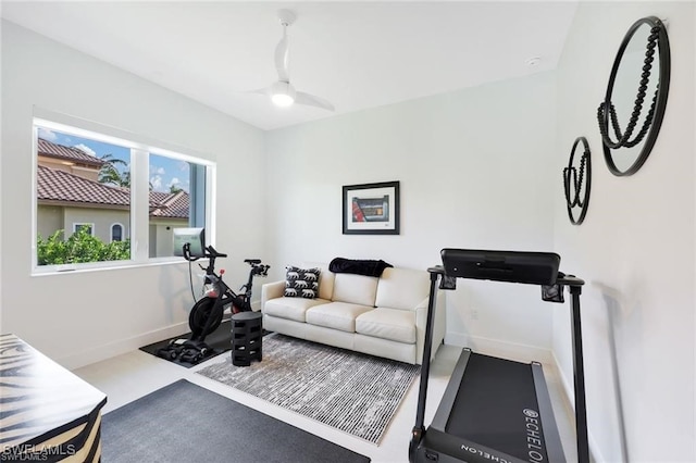 workout room featuring baseboards and a ceiling fan