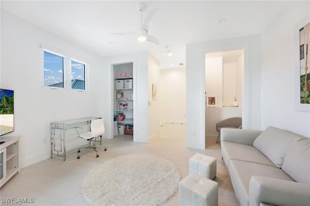 living area featuring ceiling fan, built in features, baseboards, and recessed lighting